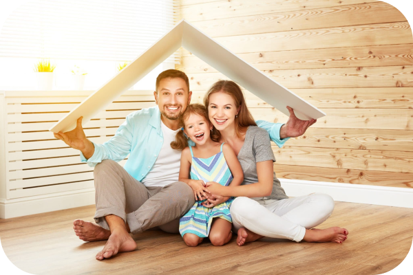 family smiling happily inside home